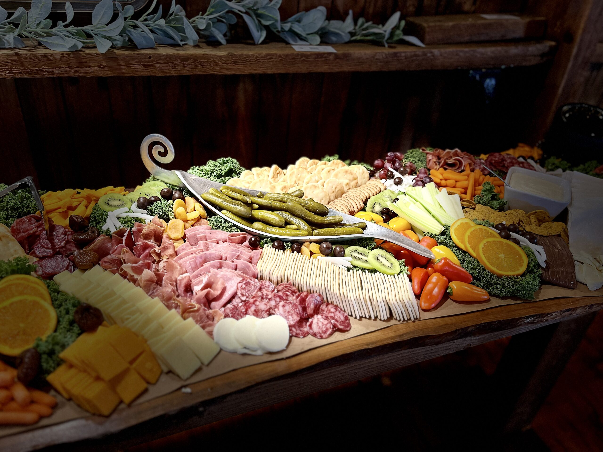 A vibrant charcuterie board featuring an array of meats, cheeses, fruits, and crackers, artfully arranged for a festive gathering.