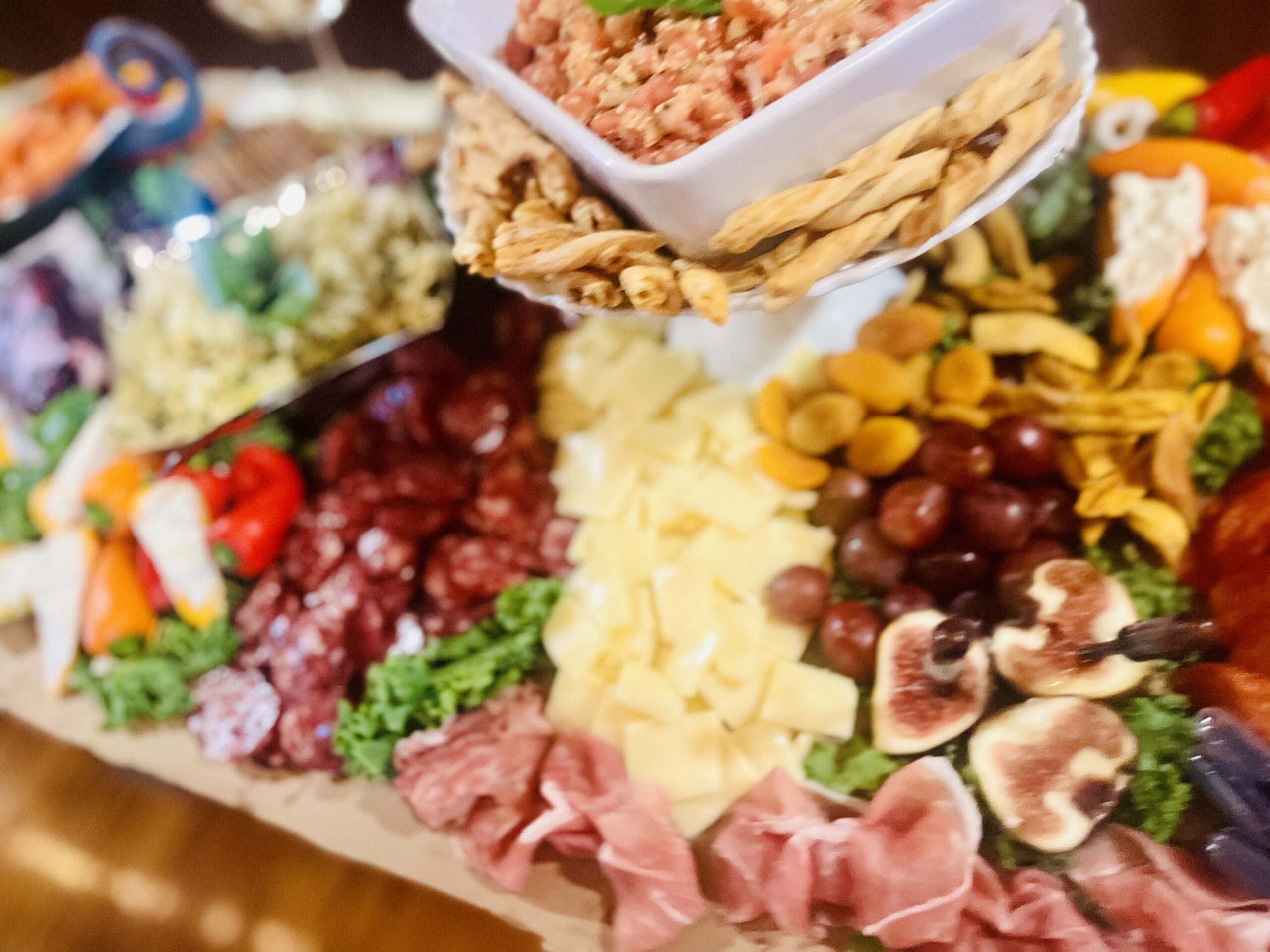 A vibrant charcuterie platter featuring assorted meats, cheeses, fruits, and crackers, ideal for entertaining and showcasing culinary diversity.